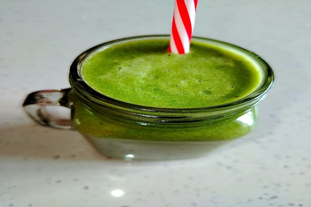green smoothie made with spinach, cucumber, green apple, banana and lemon