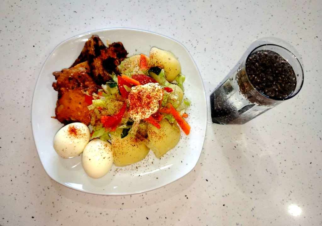 High protein spicy dinner with chicken, eggs, potatoes and salad for weight loss after 40